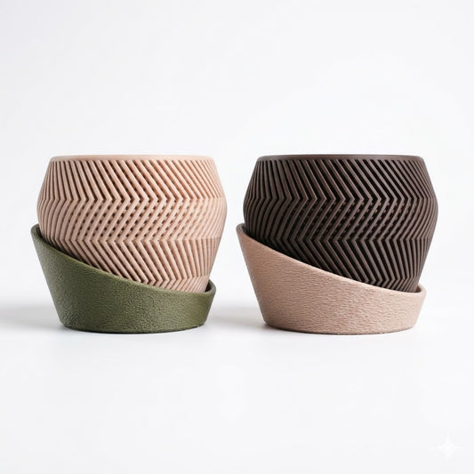 Alt Text (main hero image)
Braga Planter in two colour combinations — bone with olive green drip tray and dark chocolate with bone drip tray — showing chevron herringbone pattern and sculptural asymmetric drip tray — 3D printed indoor planter by Lux Print Labs