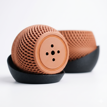 Brown textured object with black base on a white background
