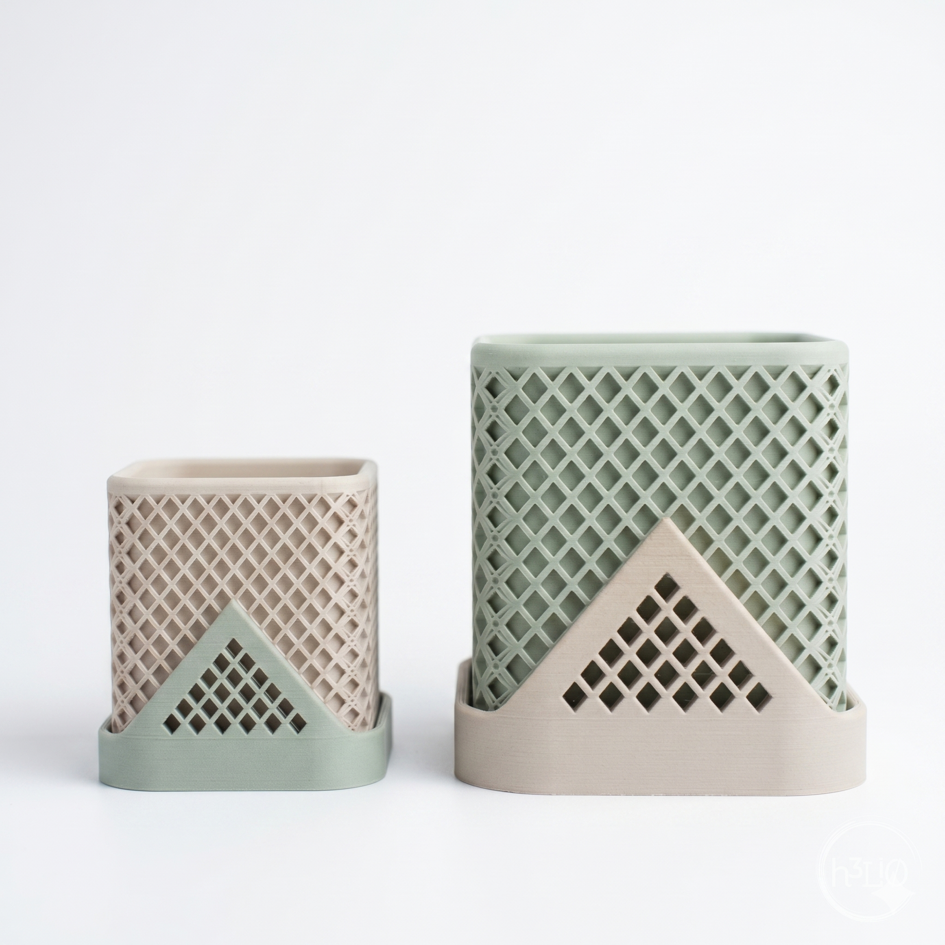 Two Square Polygon Planters featuring an architectural lattice texture and a ceramic-like matte finish, housing succulents in a minimalist, light-filled setting.