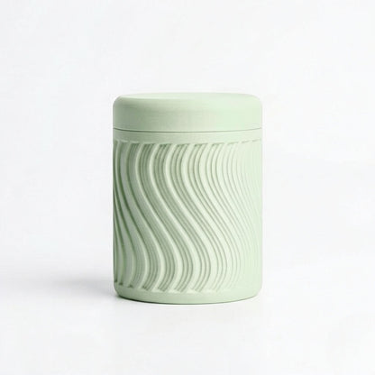 Lux Print Labs light green PLA storage container with lid, featuring a textured wave pattern. Modern design, 74mm x 74mm x 96mm.