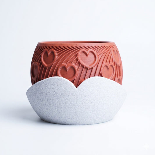 Lux Print Labs terracotta heart planter with embossed arc pattern and a sculptural white cloud-shaped drip tray.