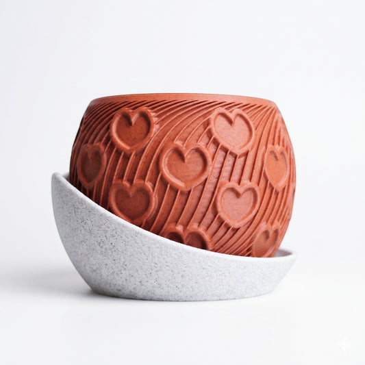 Lux Print Labs terracotta-colored PLA heart planter with embossed arc pattern and a speckled white cloud drip tray.