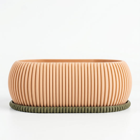 Lux Print Labs 3D printed peach bonsai planter with a ribbed texture and a contrasting olive green drip tray.