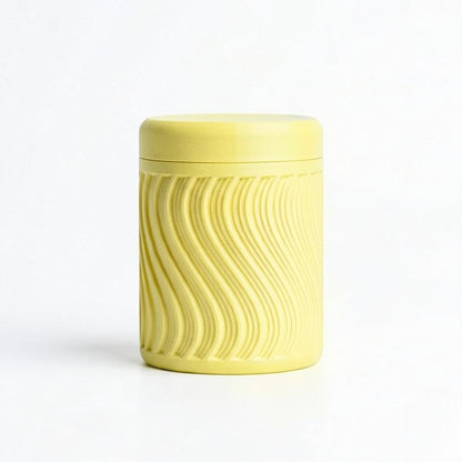 Lux Print Labs yellow PLA storage container with a textured wave pattern and lid, perfect for trinkets.