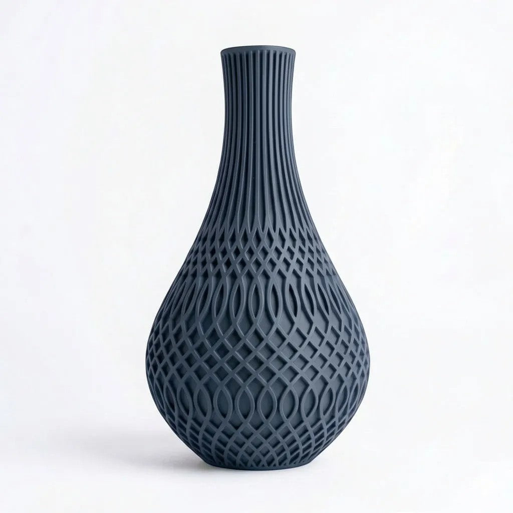 Lux Print Labs Inflect Vase in dark grey, featuring a teardrop silhouette with vertical fluting transitioning to a woven lattice pattern. Made from matte PLA.